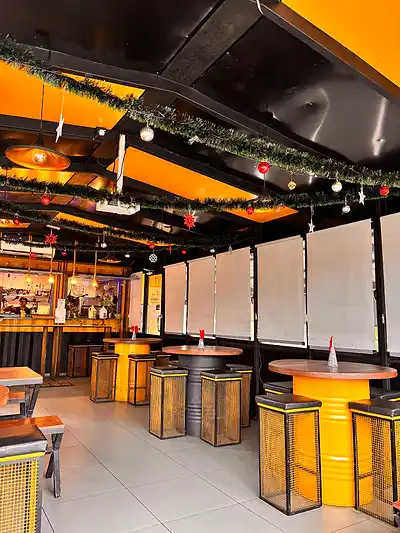 Bar seating with yellow stools at The Octa