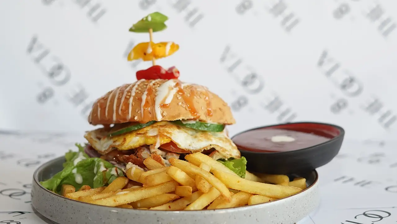 Stacked burger with French fries and dip