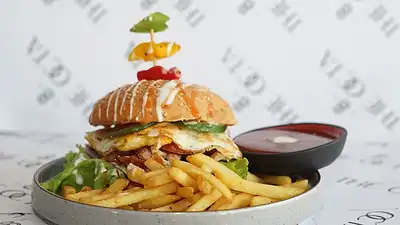 Stacked burger with French fries and dip