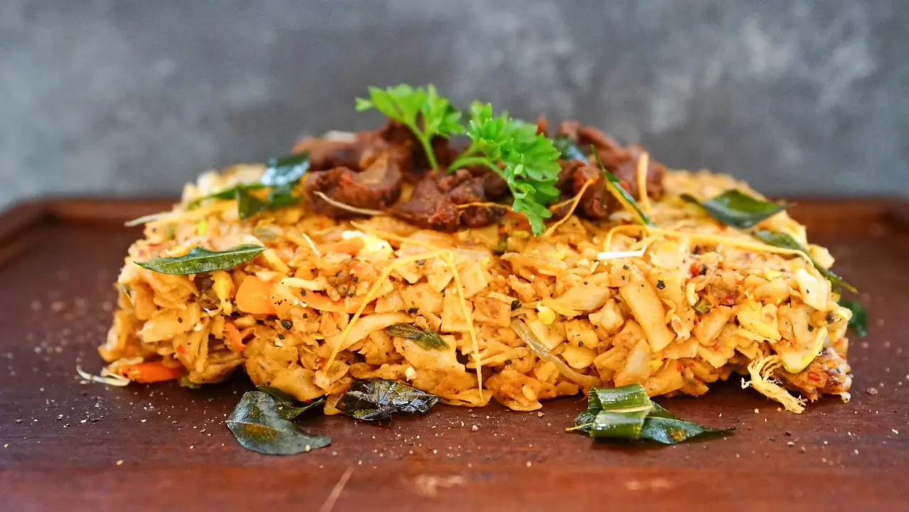 Chicken kottu on a wooden board