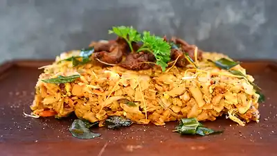 Chicken kottu on a wooden board