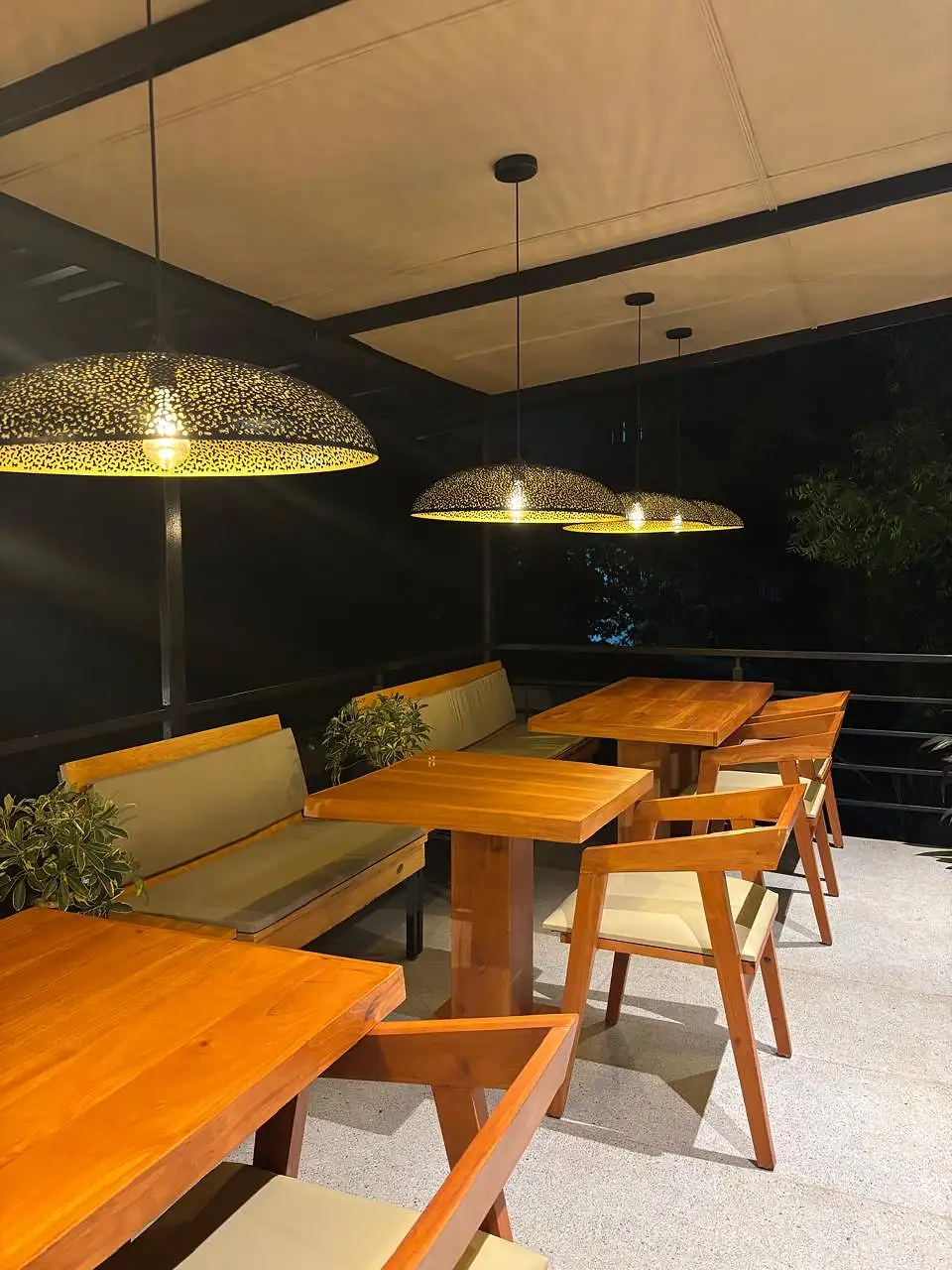 Evening dining area with woven pendant lights