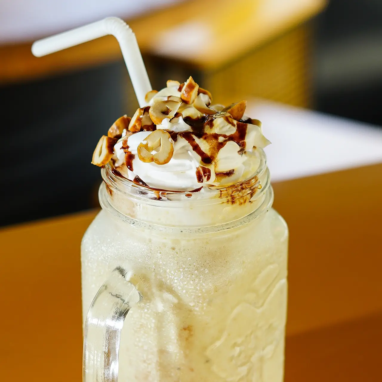 Iced milkshake topped with whipped cream and chocolate sauce