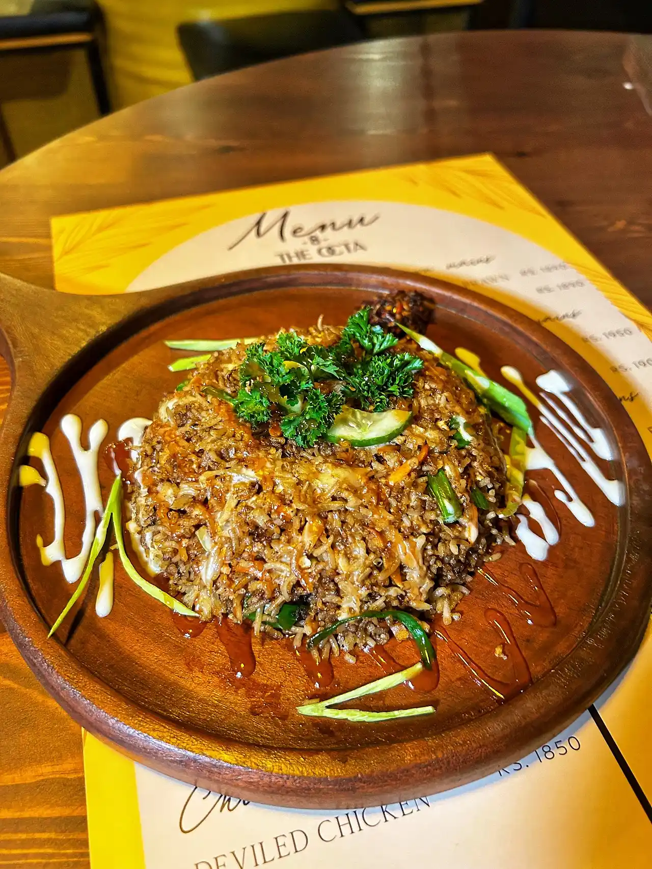Kottu served on a wooden plate over The Octa menu