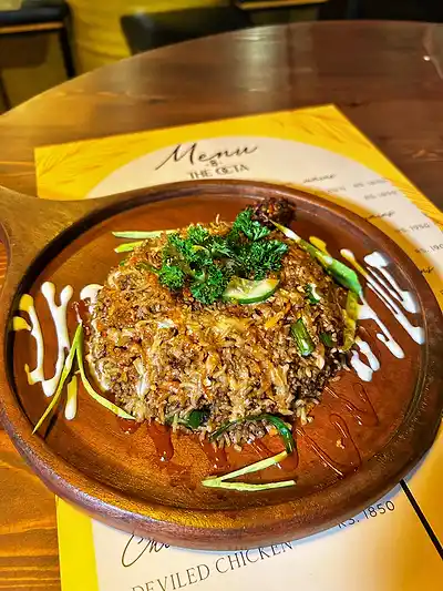 Kottu served on a wooden plate over The Octa menu