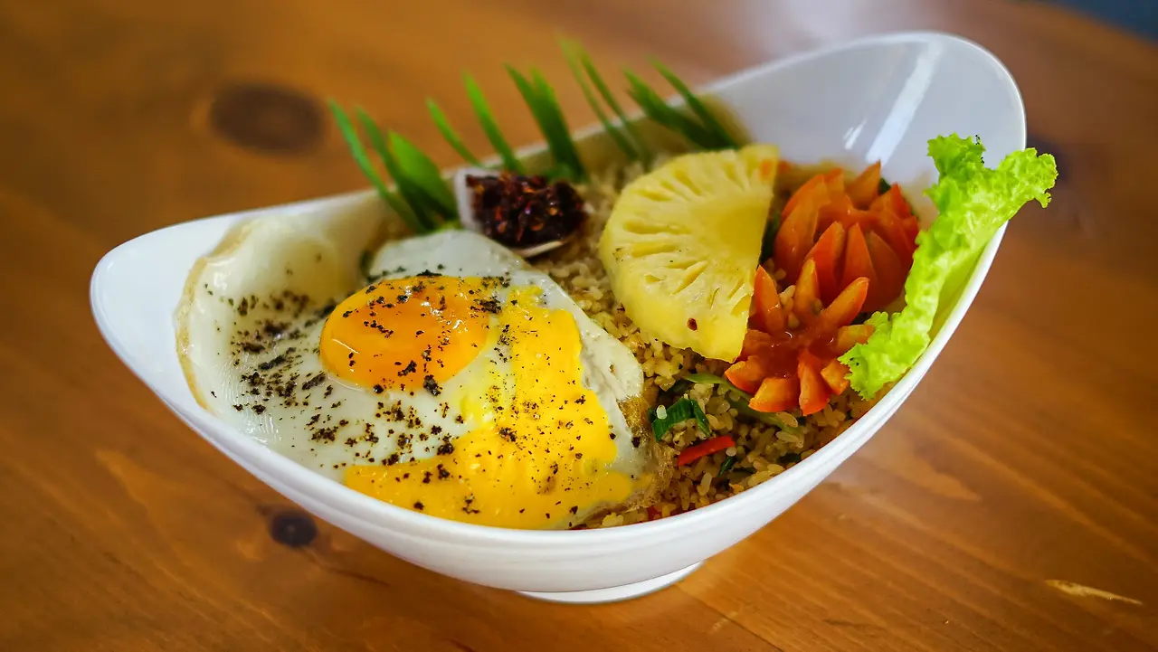 Rice bowl with a fried egg, grilled pineapple and chilli paste
