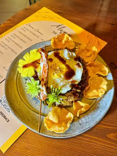 Chicken nasi goreng with a fried egg, prawn crackers and pineapple