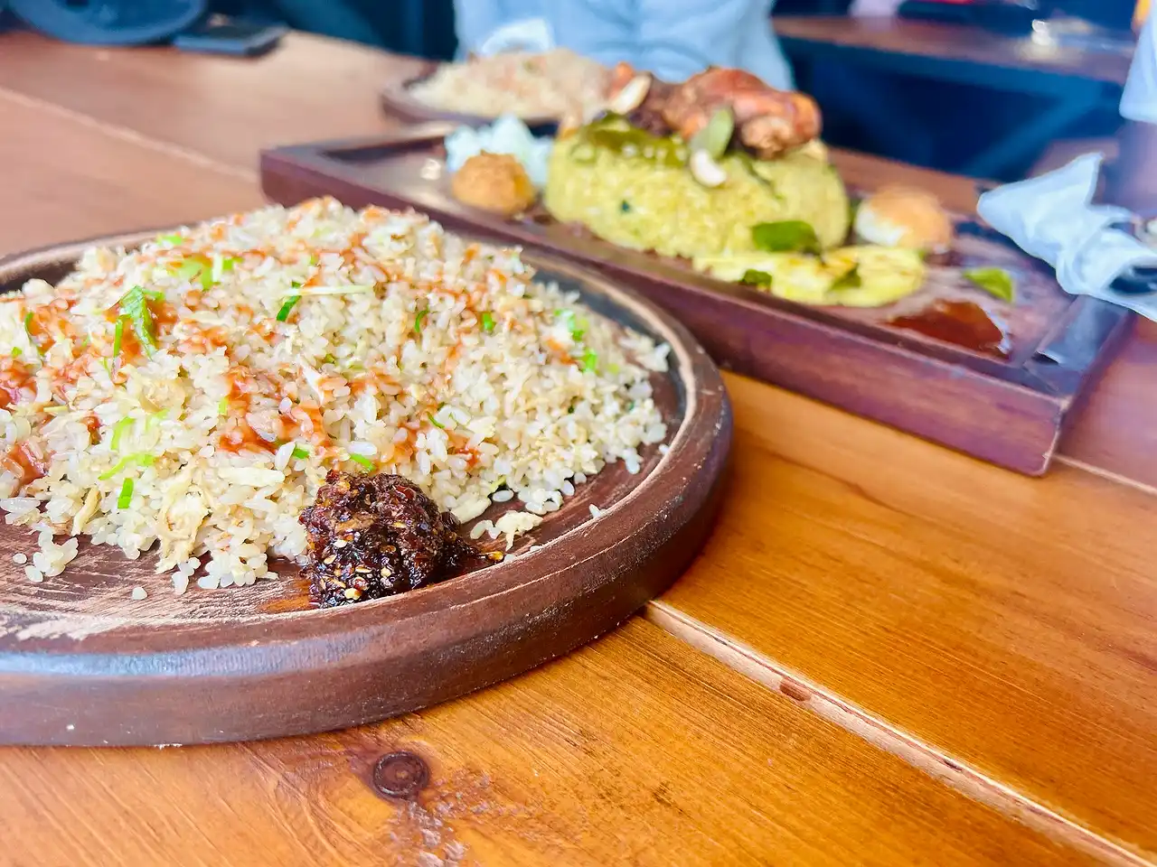 Budget chicken mix fried rice served on a wooden plate, photographed by a guest