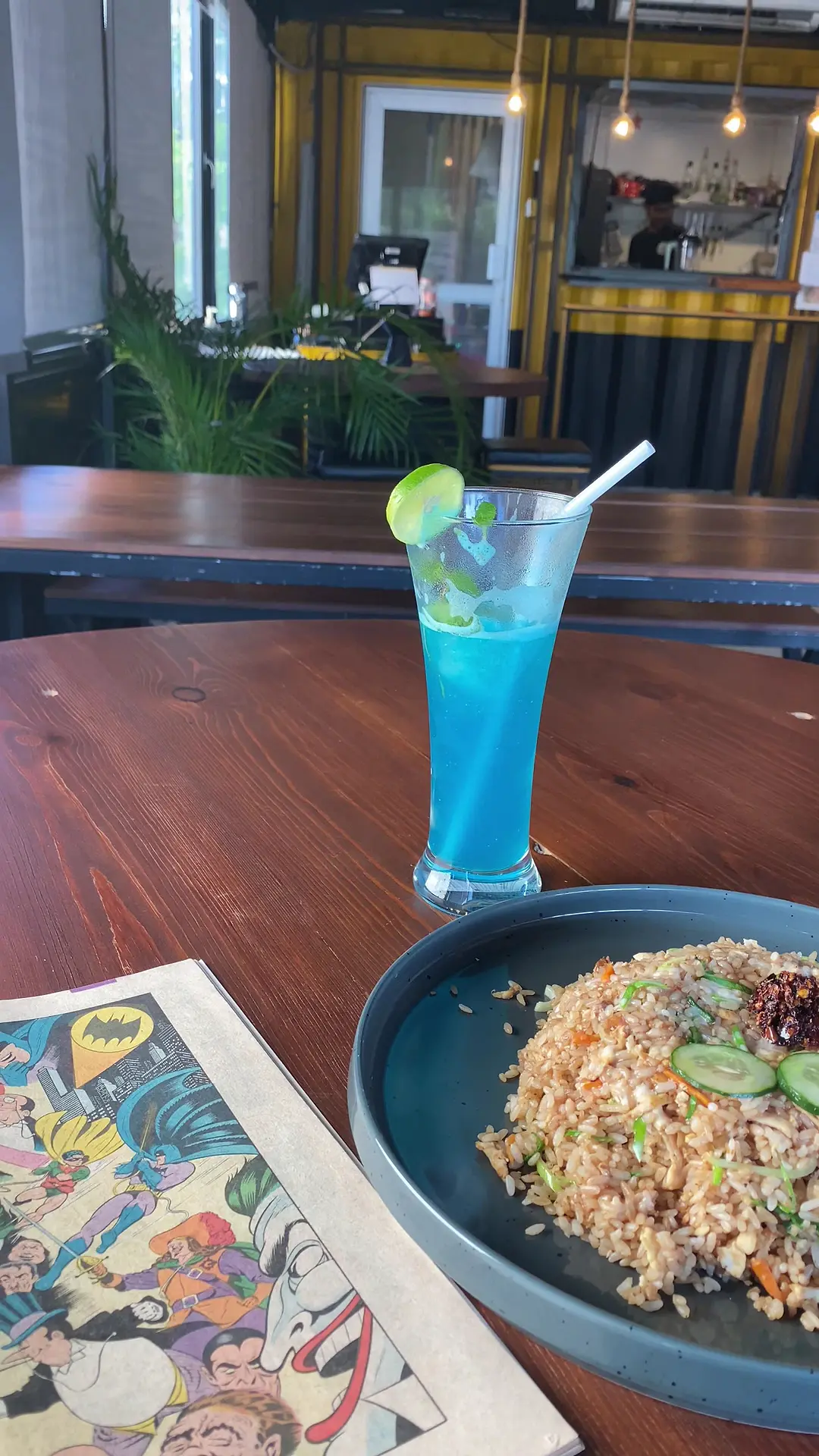 Blue mocktail and fried rice on a table at The Octa, photographed by a guest