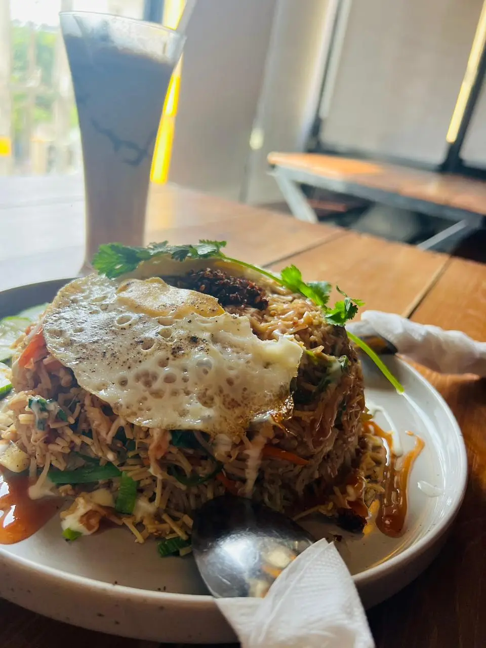 Fried rice topped with a fried egg, photographed by a guest