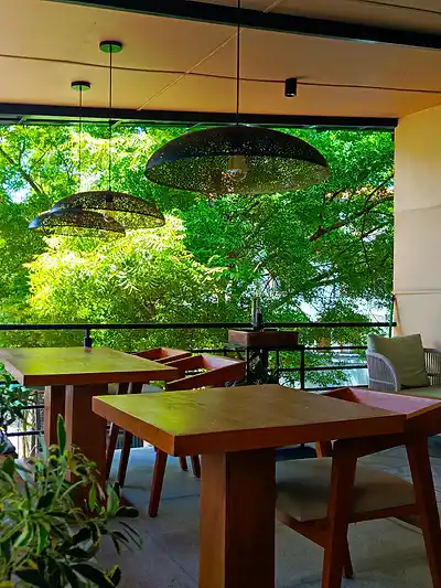 Terrace seating at The Octa with pendant lamps and trees
